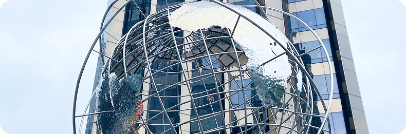 Sculpture of a globe in front of a building