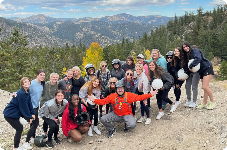 Group of hikers with mountains behind them